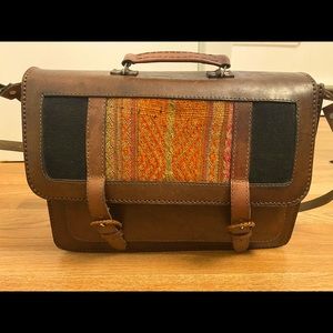 Genuine leather bag with embroidered detail.